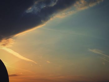 Low angle view of rainbow against sky during sunset