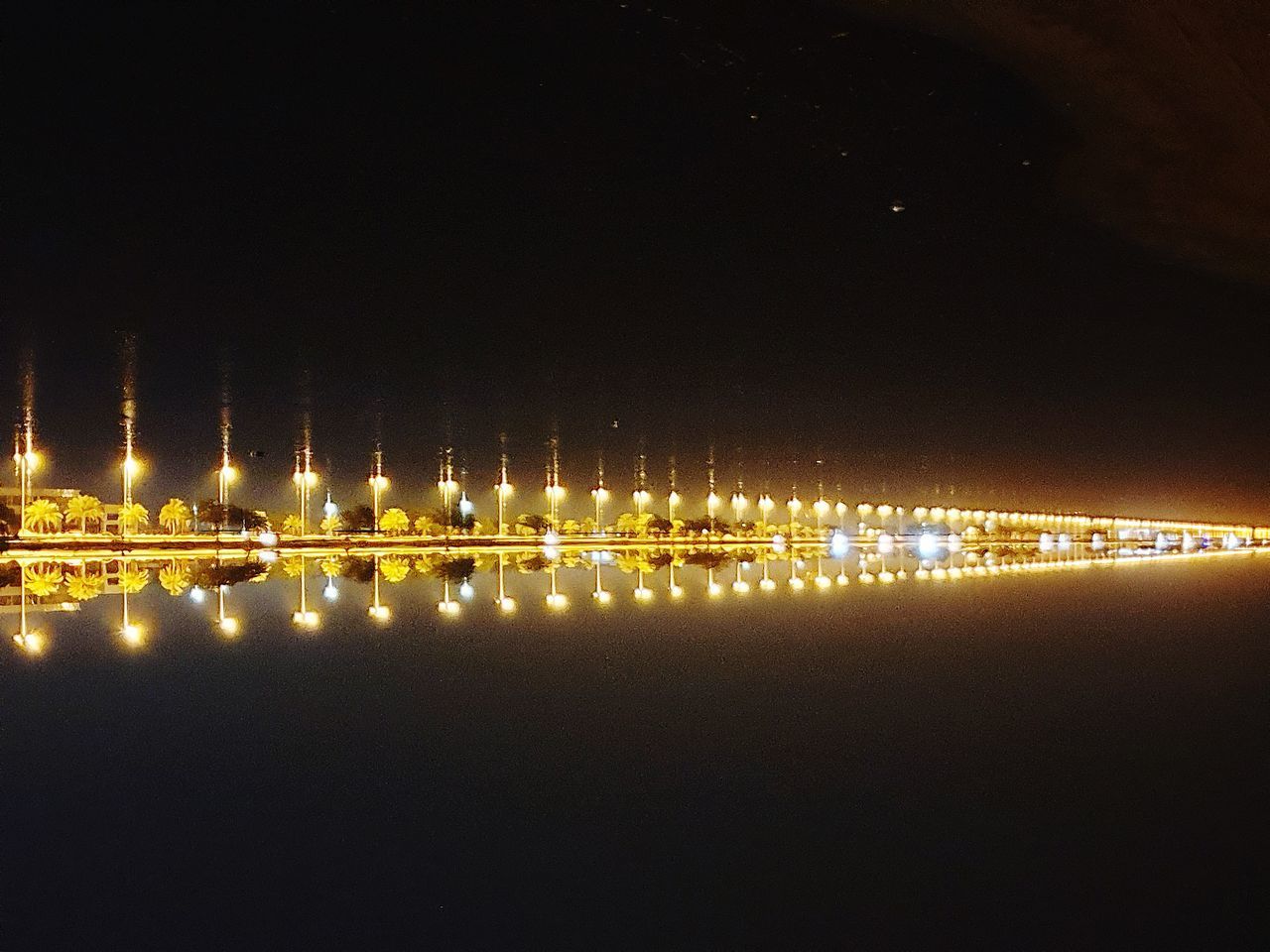 REFLECTION OF ILLUMINATED BUILDINGS IN WATER