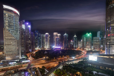 Illuminated buildings against sky at night