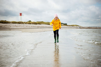 Full length of girl walking at beach