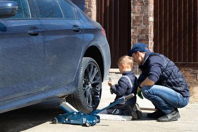 Side view of man working on street