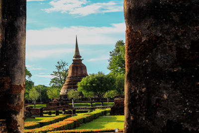 Panoramic view of trees and building against sky