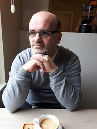 Thoughtful man sitting at table