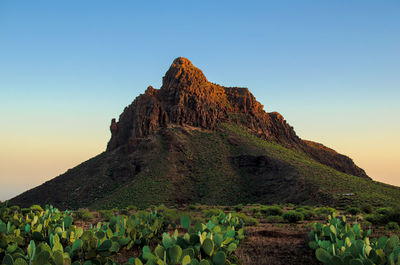 Rock formations on mountain against clear sky
