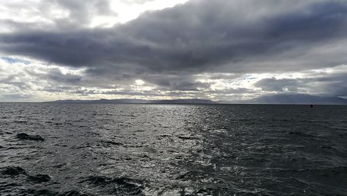 Scenic view of sea against storm clouds