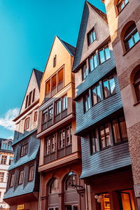 Low angle view of residential building against blue sky