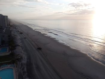 Scenic view of beach against sky during sunset