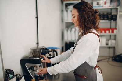 Side view of young woman holding food