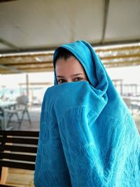 Portrait of woman covering face with towel