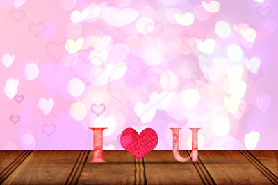 Close-up of heart shape on pink table