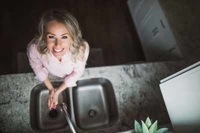 Portrait of smiling woman using mobile phone