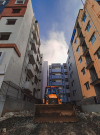 Low angle view of buildings in city against sky