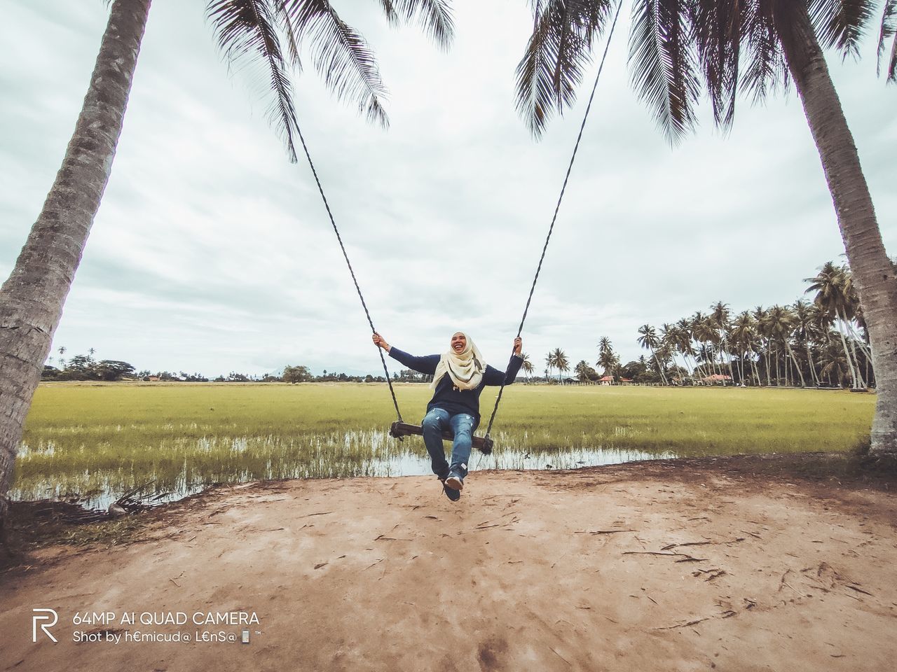 FULL LENGTH OF YOUNG WOMAN WITH PALM TREE