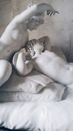 Close-up of female statue on bed