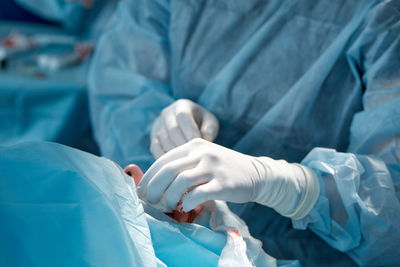 Midsection of surgeon operating in hospital