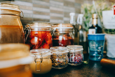 Close-up of various herbs in jar on table