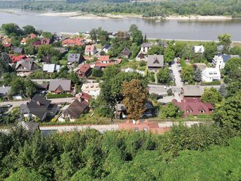 High angle view of houses by lake and buildings