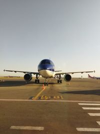 Airplane on runway against sky