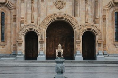 Statue against historic building in city