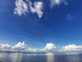 Scenic view of sea against blue sky with cloud