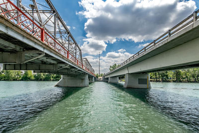 Low angle view of bridge over river against sky