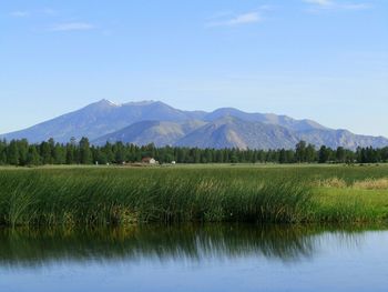 Scenic view of lake against mountain background