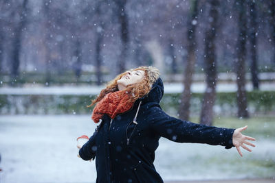 Close-up of woman standing on snow during rainy season