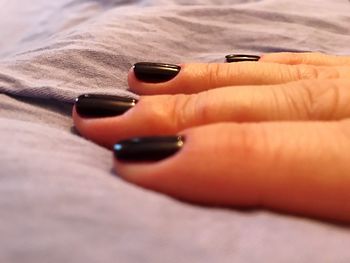 Cropped image of hand with black nail polish