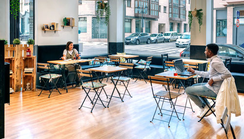 Empty chairs and tables in restaurant