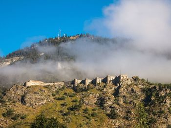 Panoramic view of mountain against blue sky