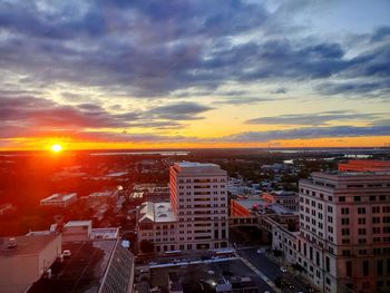 High angle view of street and buildings against sky during sunset