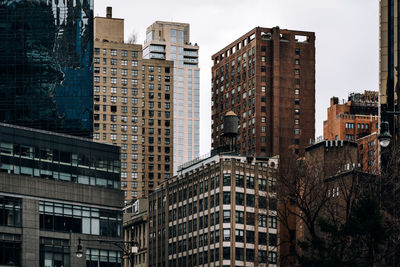 Low angle view of buildings in city against sky