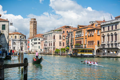 Boats in canal along buildings