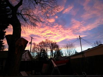 Silhouette trees against sky at sunset