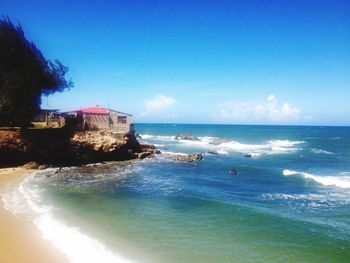 Scenic view of sea against blue sky