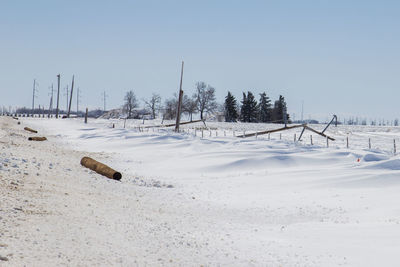 Scenic view of snow covered field against clear sky