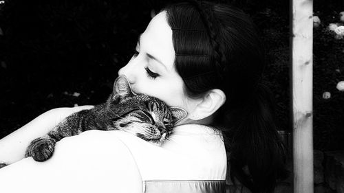 Woman embracing cat