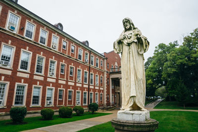 Low angle view of statue against building