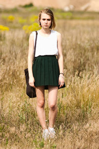 Portrait of woman standing on field