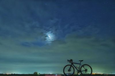 Bicycle against sky at night