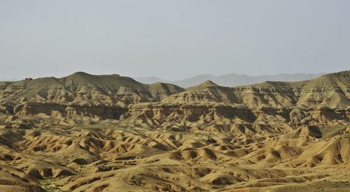 Scenic view of arid landscape against clear sky