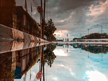 Reflection of buildings in lake against sky