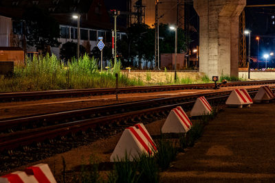 Railroad tracks in city at night