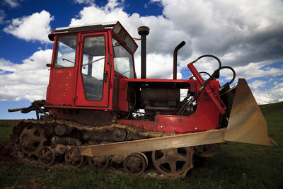 Abandoned train on field against sky