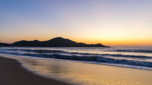 Scenic view of sea against clear sky during sunset