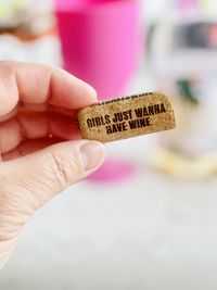 Close-up of hand holding a cork