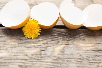 Close-up of broken eggs on wood