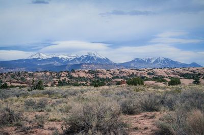 Scenic view of mountains against cloudy sky