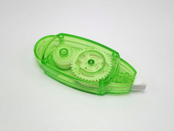 Close-up of green toy over white background