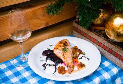 Baked chicken with slices of cooked beets, wild mushrooms and cream. a festive new year's eve dish.